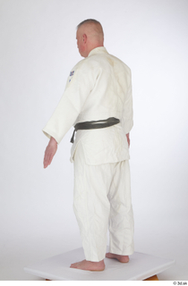 Yury A poses dressed sports standing white kimono dress whole…